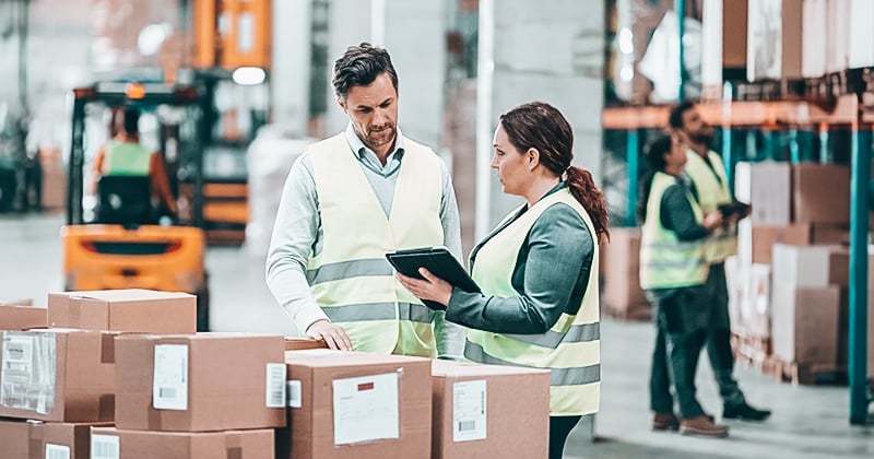 A warehouse manager handling inventory using rental software